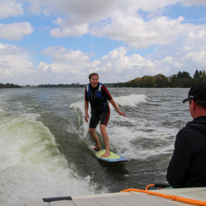 Joanna surfing behind the boat